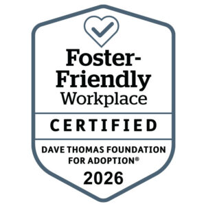 Shield-shaped badge with a heart and checkmark, labeled Foster-Friendly Workplace Certified. Text below reads Dave Thomas Foundation for Adoption 2026.