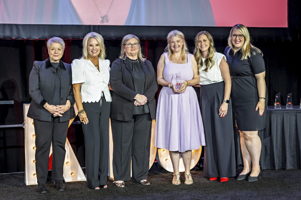 Corinna onstage accepting her award with Foundation Staff.